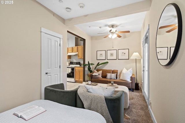 bedroom featuring beamed ceiling, ceiling fan, and light carpet