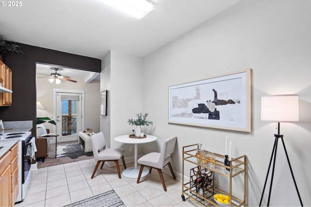 dining room featuring light tile patterned floors, beamed ceiling, and ceiling fan