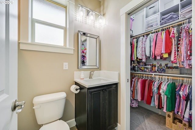 bathroom featuring toilet and vanity