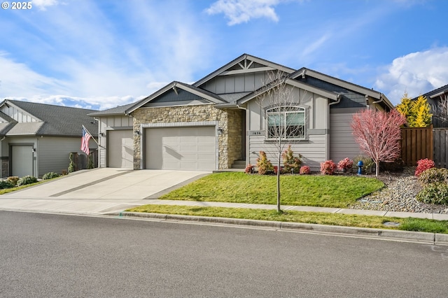 craftsman inspired home with a garage and a front yard