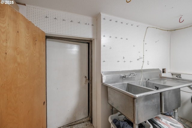 kitchen featuring crown molding and a sink