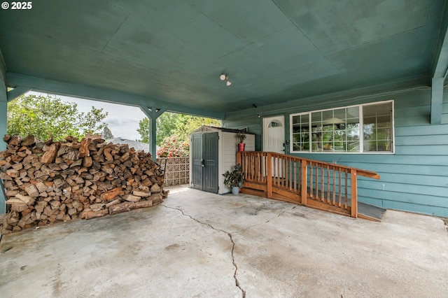 view of patio / terrace featuring a storage shed and an outbuilding