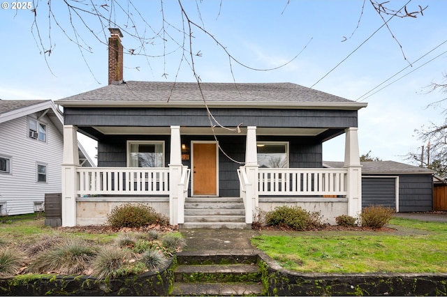 bungalow with a front yard and covered porch