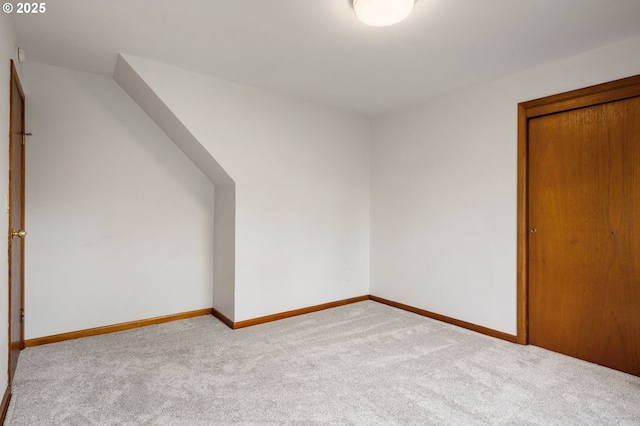 additional living space with carpet flooring and baseboards