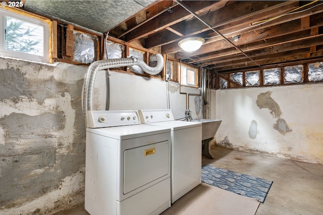 laundry room featuring laundry area, washing machine and dryer, and a sink