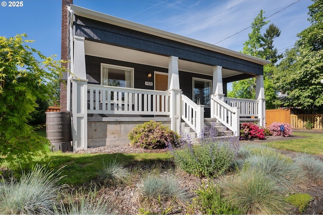 exterior space featuring an outdoor structure, a fenced backyard, a wooden deck, and a lawn