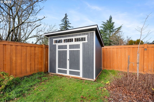 view of shed with a fenced backyard