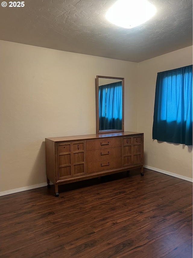 2711 Bowman Rd, Reedsport, OR 97467 - unfurnished bedroom featuring dark wood-style flooring