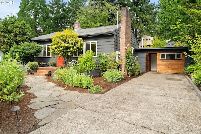 8160 SW 41st Ave, Portland, OR 97219 - view of front facade with driveway and a chimney