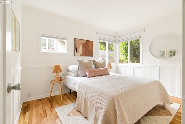 8160 SW 41st Ave, Portland, OR 97219 - bedroom featuring light wood finished floors, wainscoting, and a decorative wall