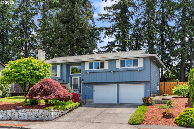 15648 NE Rose Pkwy, Portland, OR 97230 - raised ranch with driveway, a chimney, and an attached garage