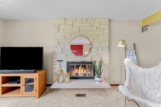 15648 NE Rose Pkwy, Portland, OR 97230 - living area with carpet floors, a fireplace, and a textured ceiling
