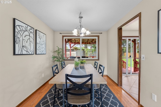 15648 NE Rose Pkwy, Portland, OR 97230 - dining area featuring a chandelier, healthy amount of natural light, and light wood-style flooring