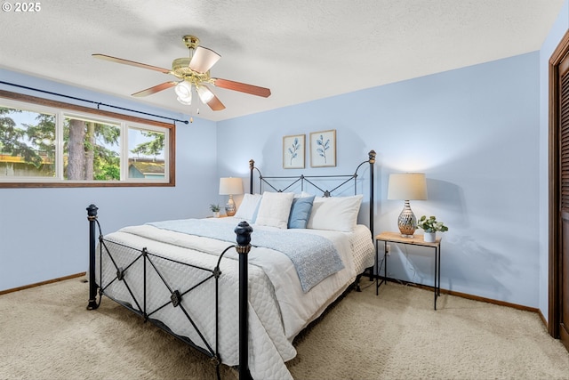 15648 NE Rose Pkwy, Portland, OR 97230 - carpeted bedroom with baseboards, ceiling fan, a textured ceiling, and a closet