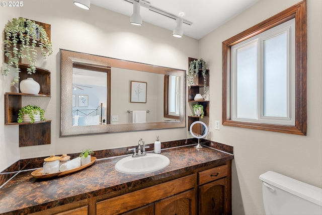15648 NE Rose Pkwy, Portland, OR 97230 - half bathroom with toilet, vanity, and rail lighting