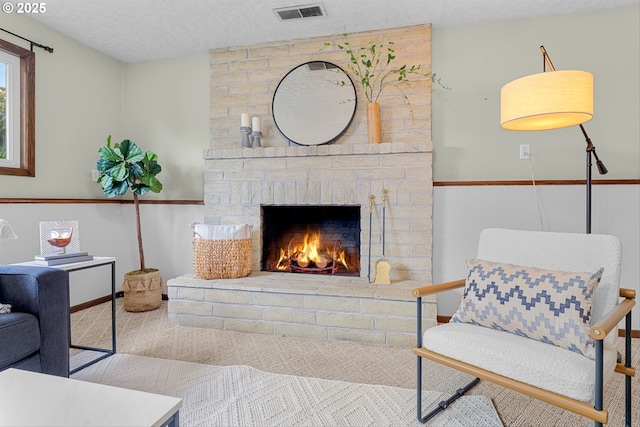 15648 NE Rose Pkwy, Portland, OR 97230 - sitting room with a fireplace, carpet flooring, and a textured ceiling