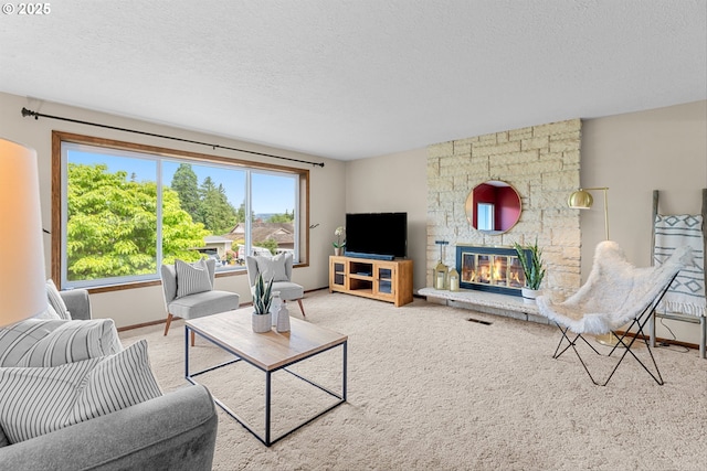 15648 NE Rose Pkwy, Portland, OR 97230 - carpeted living area with a textured ceiling, baseboards, and a fireplace