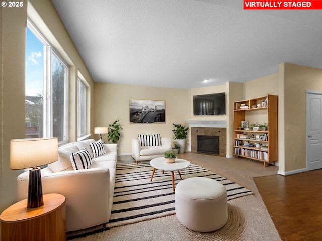 living room with carpet flooring, a fireplace, and baseboards