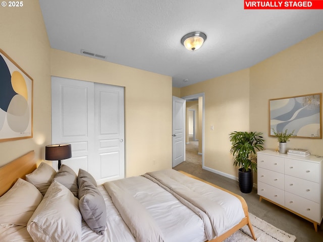 bedroom featuring carpet floors, a closet, visible vents, and baseboards