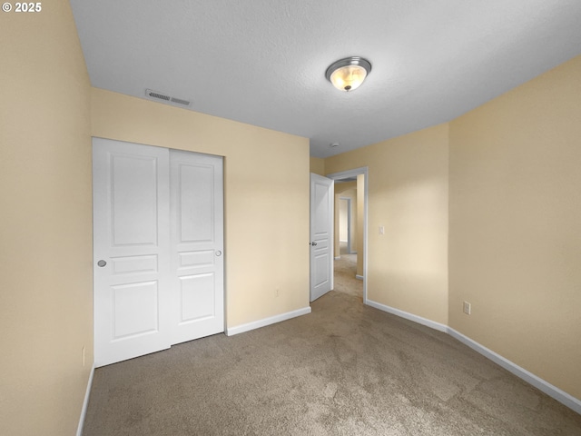 unfurnished bedroom featuring baseboards, visible vents, and a closet