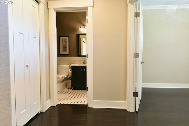 3225 SE Lincoln St, Portland, OR 97214 - hallway featuring baseboards, dark wood finished floors, and a sink