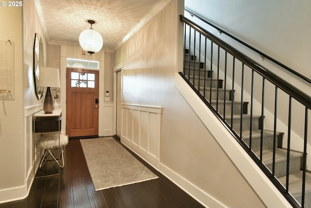 3225 SE Lincoln St, Portland, OR 97214 - entryway with ornamental molding, dark wood-type flooring, stairway, wainscoting, and a decorative wall