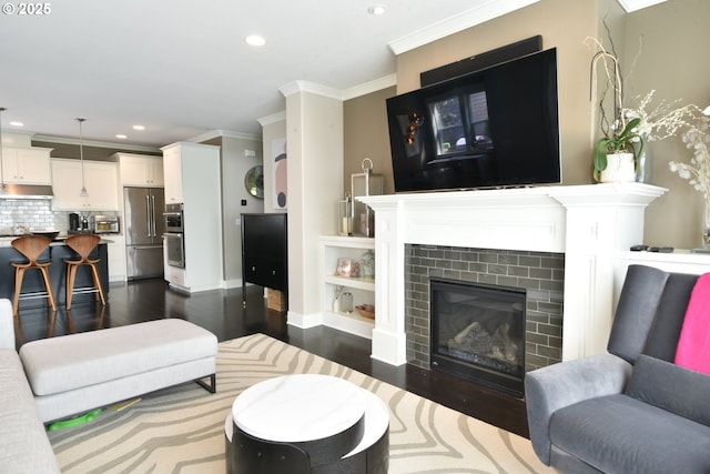 3225 SE Lincoln St, Portland, OR 97214 - living area with dark wood finished floors, ornamental molding, recessed lighting, a tile fireplace, and baseboards