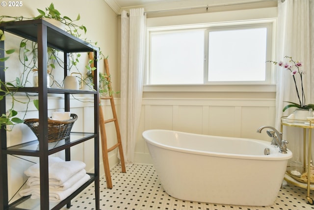 3225 SE Lincoln St, Portland, OR 97214 - full bathroom featuring a decorative wall, a freestanding tub, a wainscoted wall, crown molding, and tile patterned floors