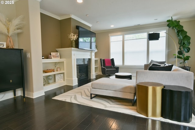 3225 SE Lincoln St, Portland, OR 97214 - living room with ornamental molding, recessed lighting, wood finished floors, a tiled fireplace, and baseboards