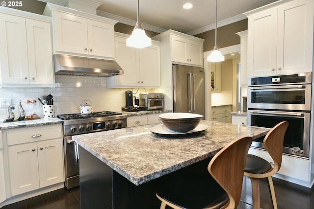 3225 SE Lincoln St, Portland, OR 97214 - kitchen with extractor fan, appliances with stainless steel finishes, ornamental molding, a kitchen island, and tasteful backsplash