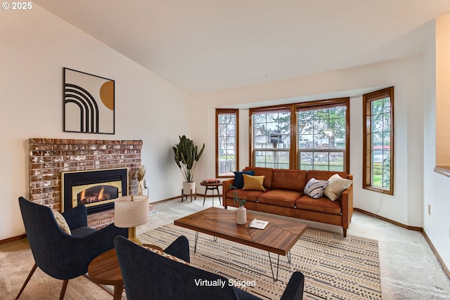 living area with plenty of natural light, a brick fireplace, light carpet, and vaulted ceiling