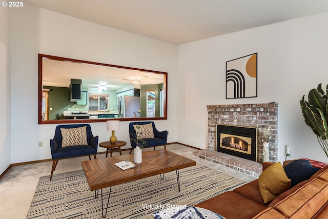 carpeted living room featuring a brick fireplace and baseboards