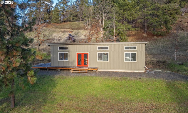 view of front of home with a front yard and french doors