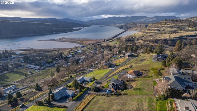 drone / aerial view with a water and mountain view