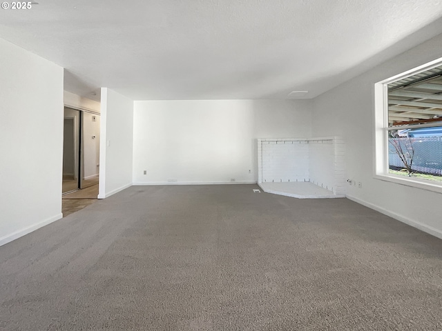 spare room featuring baseboards and carpet floors