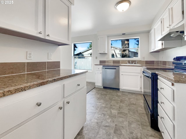 kitchen featuring under cabinet range hood, dishwasher, electric range oven, dark stone countertops, and white cabinetry