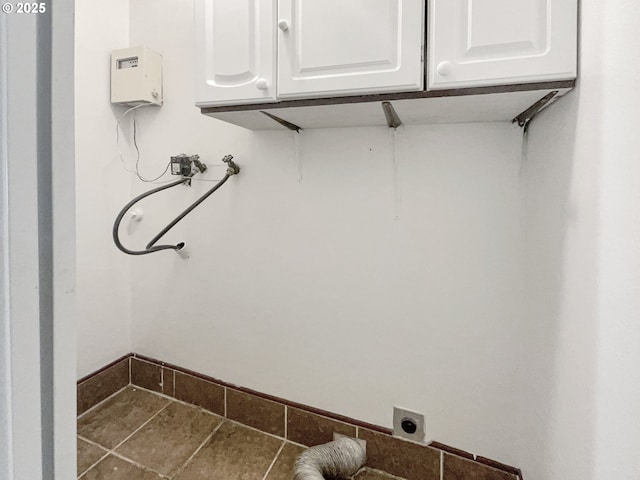 laundry area with cabinet space, hookup for an electric dryer, hookup for a washing machine, and baseboards