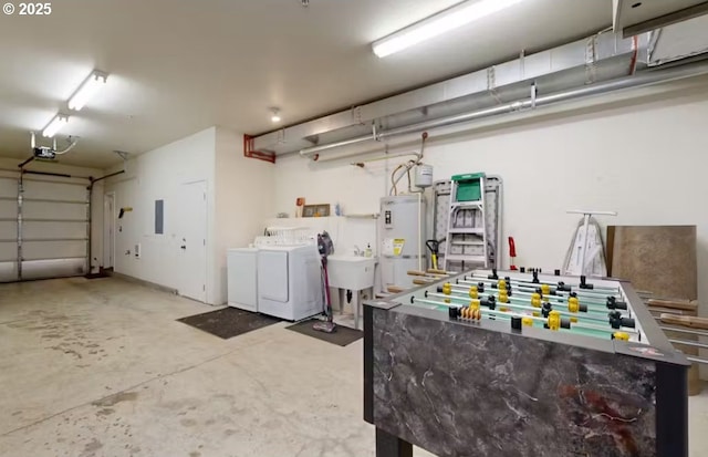 garage featuring water heater, a garage door opener, independent washer and dryer, and a sink