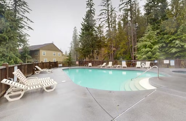pool featuring a patio area and fence