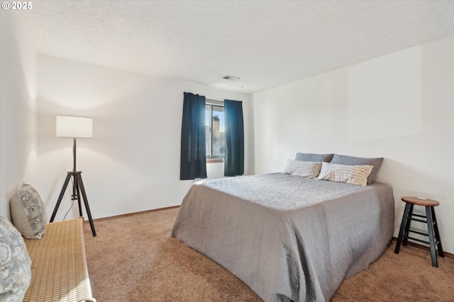 bedroom featuring carpet floors and a textured ceiling