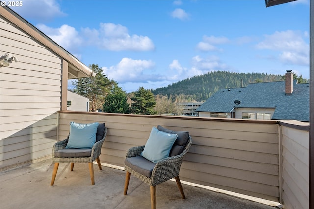 view of patio / terrace featuring a mountain view and a balcony