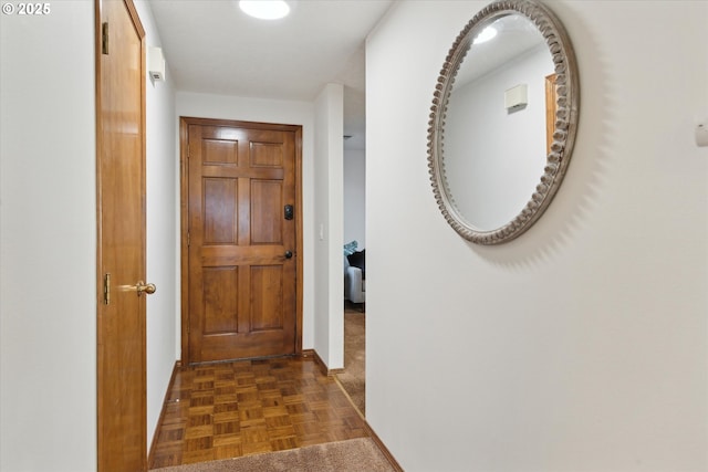 hall with dark parquet flooring