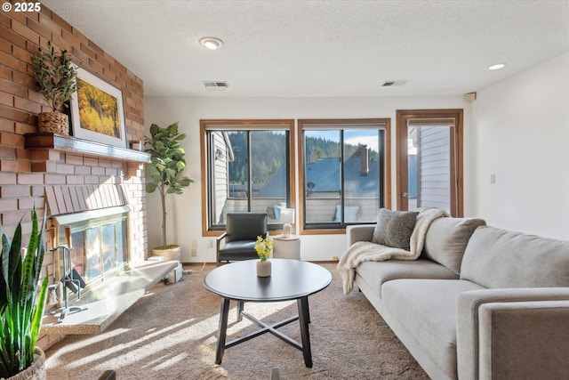 living room with a fireplace and a textured ceiling