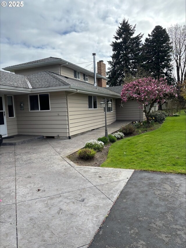 11623 Broadacres Rd NE, Hubbard, OR 97032 - view of home's exterior with a lawn, a patio, a chimney, and a shingled roof