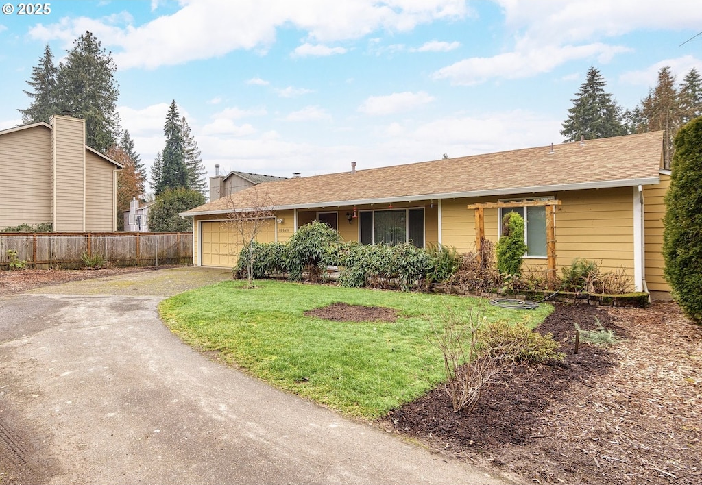 single story home featuring a front yard and a garage