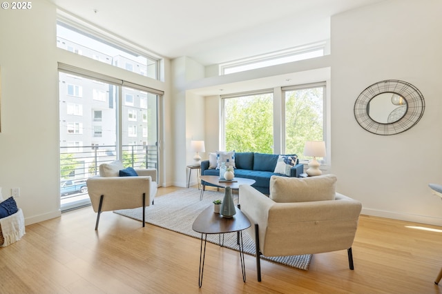 1455 N Killingsworth St Unit 201, Portland, OR 97217 - living room with plenty of natural light, wood finished floors, and baseboards