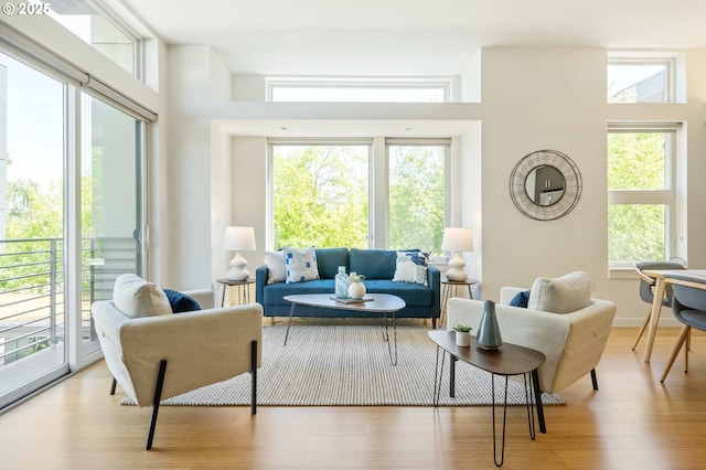 1455 N Killingsworth St Unit 201, Portland, OR 97217 - living area featuring plenty of natural light and wood finished floors