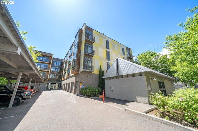 1455 N Killingsworth St Unit 201, Portland, OR 97217 - view of building exterior featuring covered parking