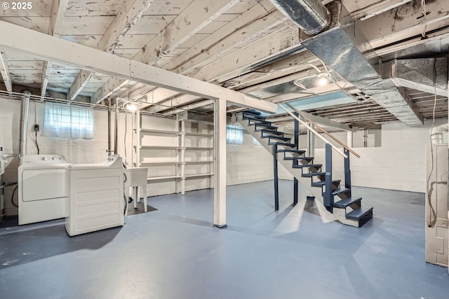 basement with a sink, stairway, and washing machine and dryer