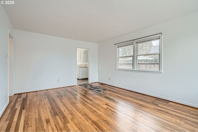 unfurnished bedroom with light wood-style floors, visible vents, and baseboards